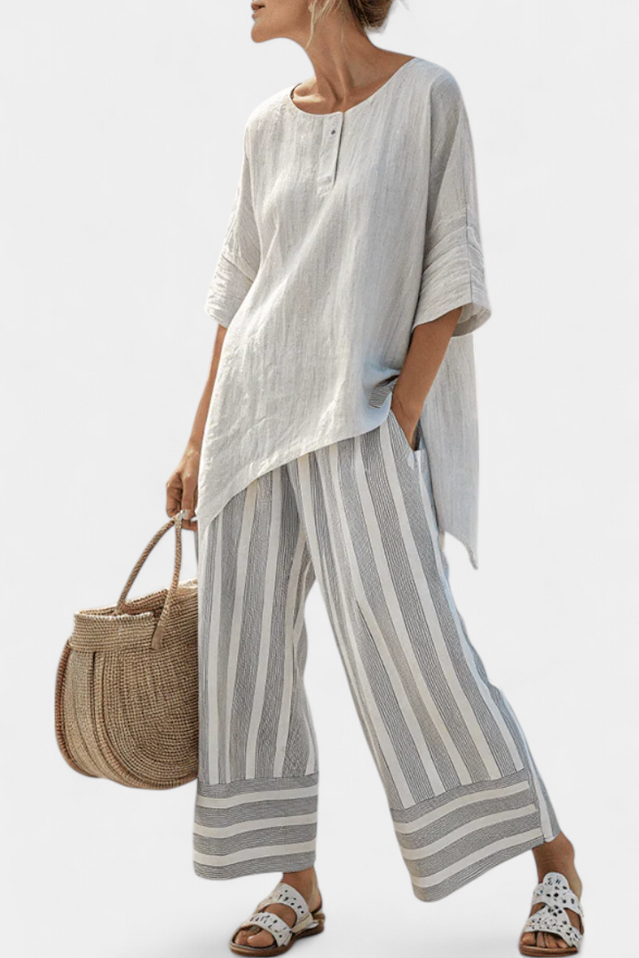 Fiorella – blusa asimmetrica elegante e pantaloni a righe